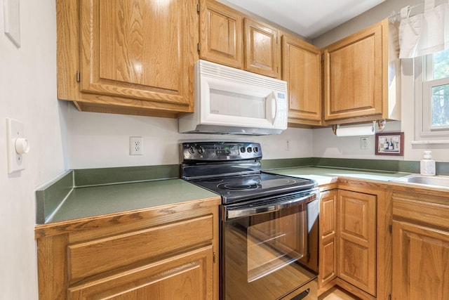 kitchen featuring white microwave and black range with electric cooktop