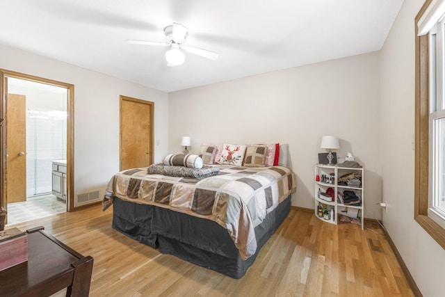 bedroom featuring visible vents, a ceiling fan, connected bathroom, light wood finished floors, and baseboards