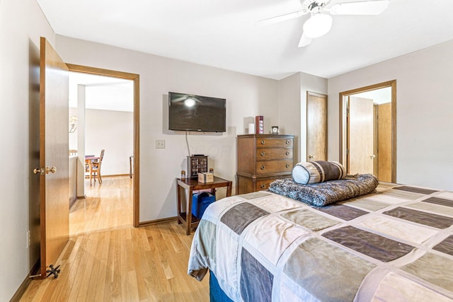 bedroom featuring a ceiling fan, baseboards, and light wood-type flooring