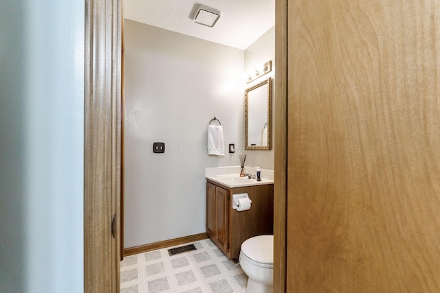 bathroom with tile patterned floors, visible vents, toilet, baseboards, and vanity