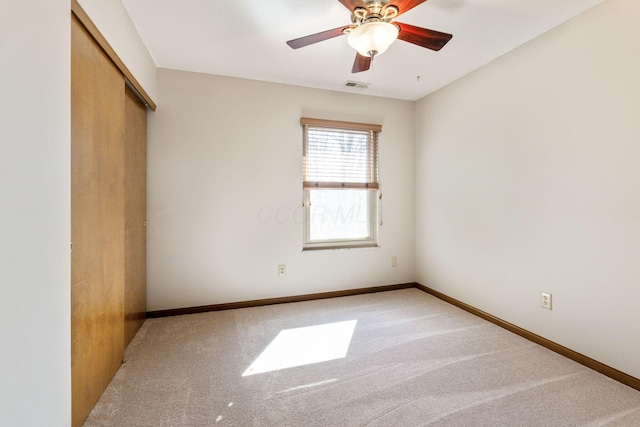 unfurnished bedroom featuring visible vents, a ceiling fan, a closet, carpet floors, and baseboards