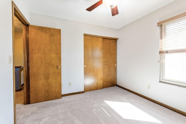 unfurnished bedroom featuring a closet, ceiling fan, baseboards, and carpet floors