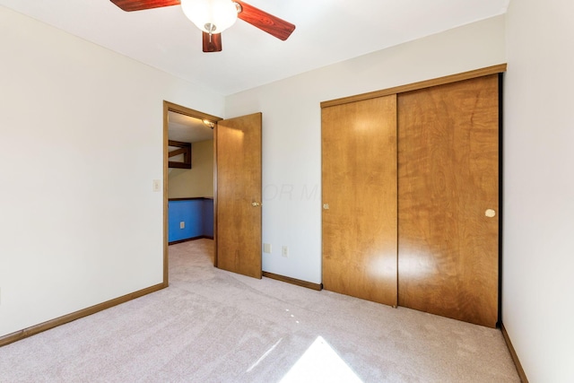 unfurnished bedroom featuring baseboards, a closet, and carpet floors