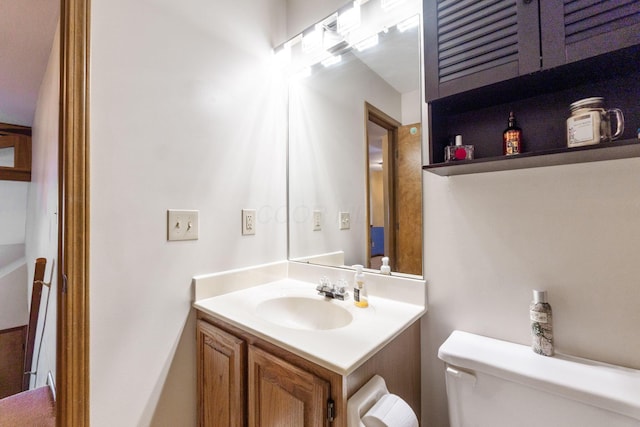 half bathroom with toilet and vanity