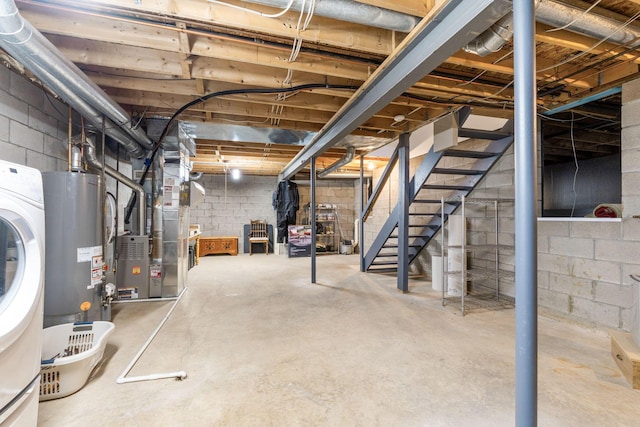 unfinished below grade area featuring stairway, heating unit, washer / dryer, and water heater