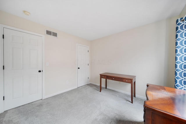 home office with carpet, visible vents, and baseboards