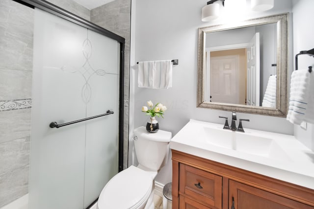 full bathroom with a shower stall, vanity, and toilet