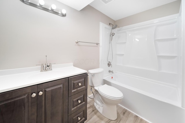 bathroom with vanity, shower / bathing tub combination, toilet, and wood finished floors