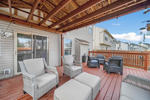 wooden terrace with a residential view and an outdoor hangout area