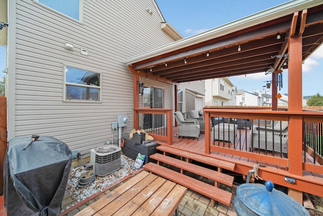 wooden deck featuring area for grilling and central AC unit