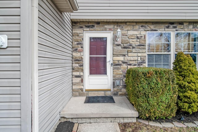 doorway to property featuring stone siding