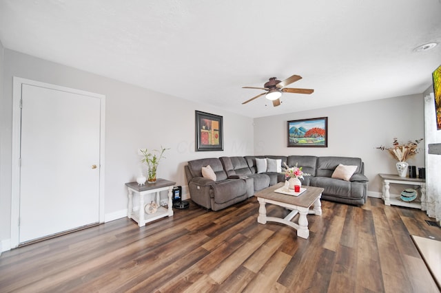 living area with a ceiling fan, wood finished floors, and baseboards