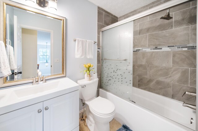 full bath with vanity, toilet, and combined bath / shower with glass door