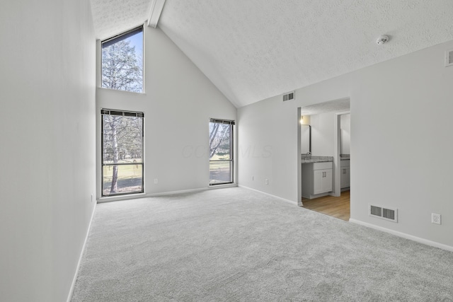 interior space with plenty of natural light, visible vents, and light carpet