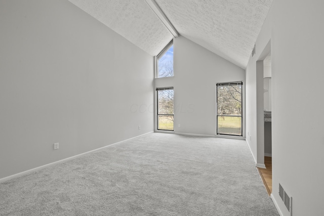 unfurnished room featuring visible vents, high vaulted ceiling, a textured ceiling, baseboards, and light colored carpet