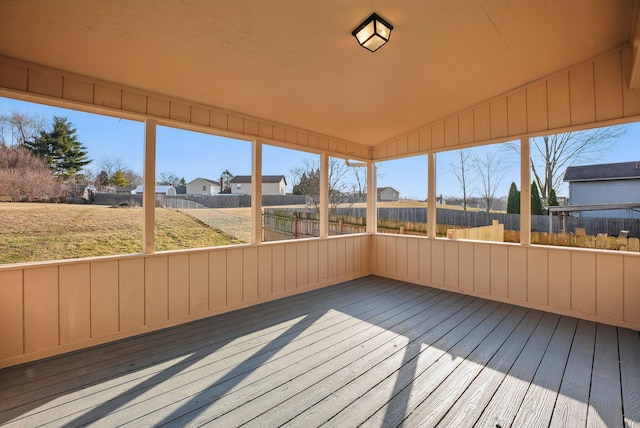 unfurnished sunroom with a wealth of natural light and vaulted ceiling