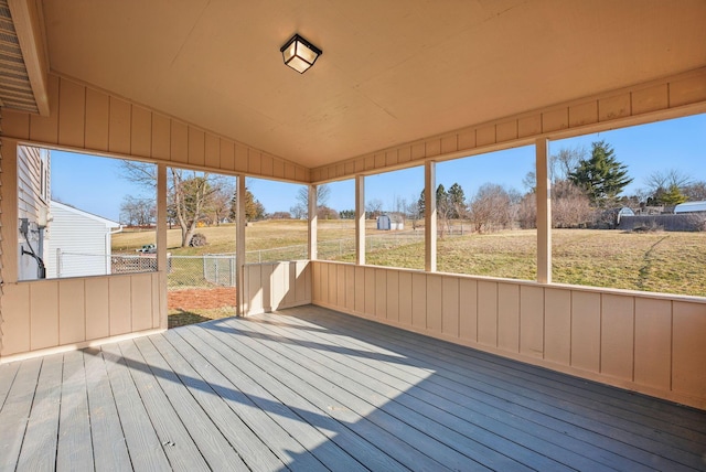 unfurnished sunroom featuring vaulted ceiling