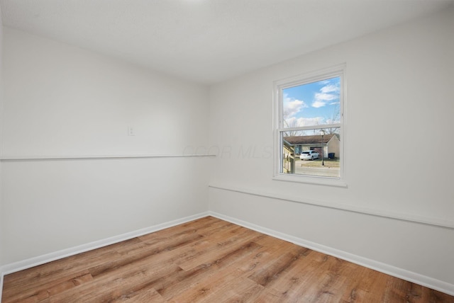 empty room with wood finished floors and baseboards