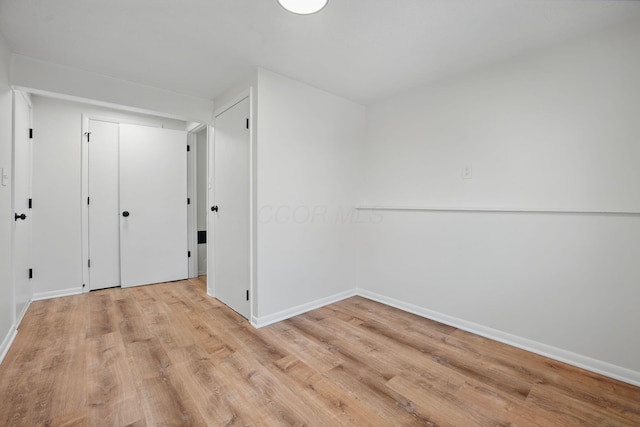 interior space with light wood-style floors and baseboards