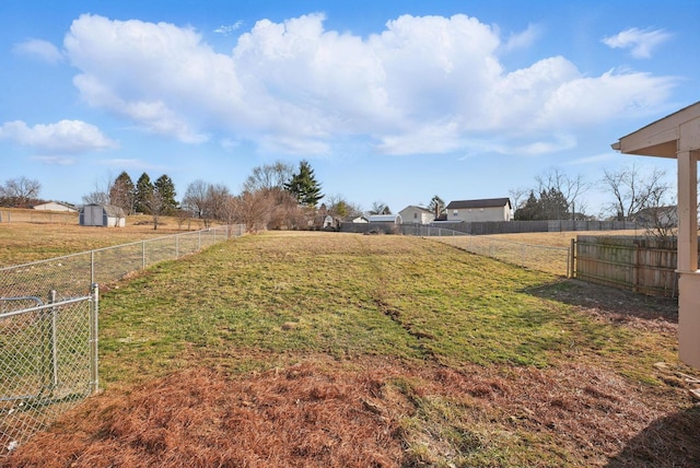 view of yard with a rural view and fence