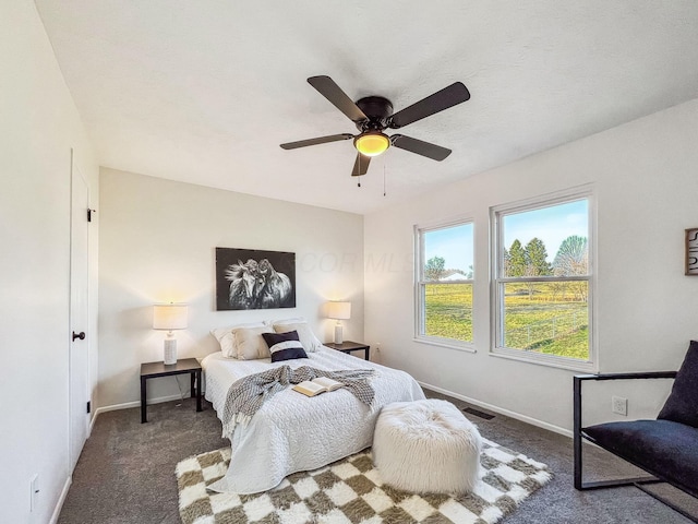 bedroom with a ceiling fan, carpet, and baseboards