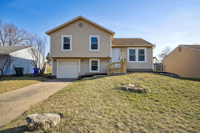 tri-level home with driveway, a front yard, and an attached garage