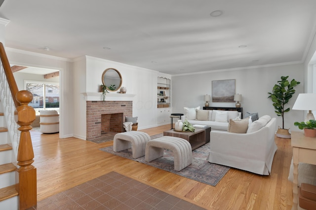 living room featuring crown molding, stairway, built in features, a fireplace, and wood finished floors