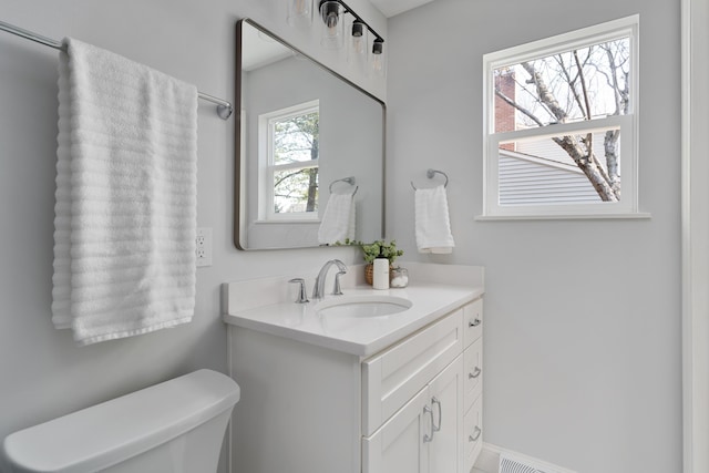 half bathroom with toilet and vanity