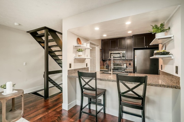 kitchen with open shelves, stainless steel appliances, backsplash, and dark wood finished floors