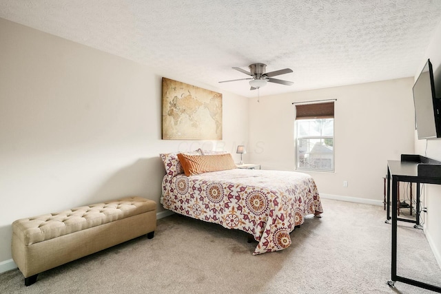 bedroom featuring carpet flooring, a ceiling fan, baseboards, and a textured ceiling