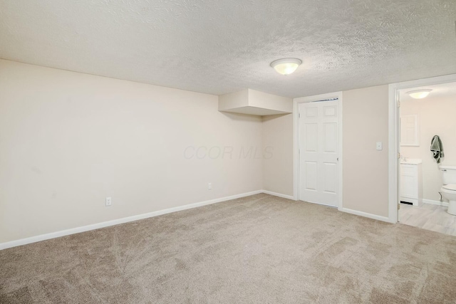 interior space with baseboards and a textured ceiling