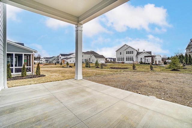 view of patio with a residential view and a sunroom