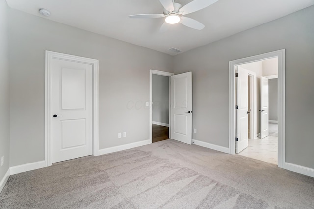 unfurnished bedroom with a ceiling fan, visible vents, baseboards, and carpet floors