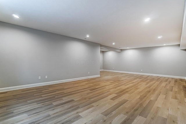 finished basement featuring recessed lighting, baseboards, and light wood-style floors