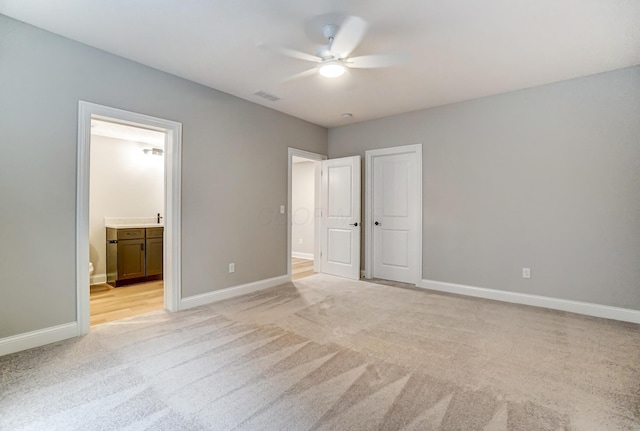 unfurnished bedroom with light colored carpet, visible vents, and baseboards