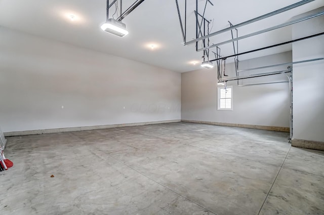 garage with a garage door opener and baseboards