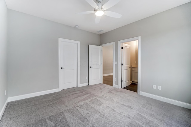 unfurnished bedroom featuring visible vents, connected bathroom, carpet, baseboards, and a ceiling fan