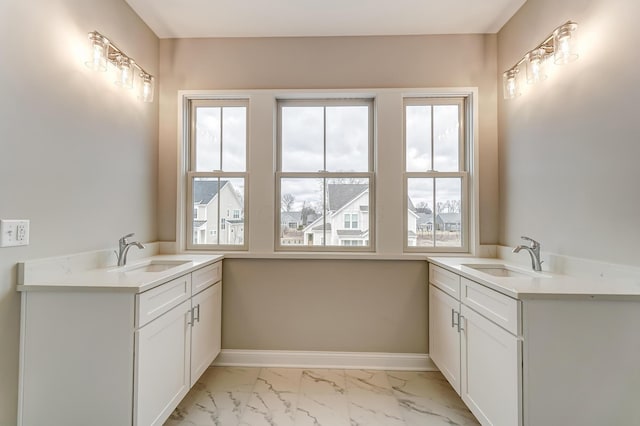 bathroom featuring vanity, baseboards, and marble finish floor