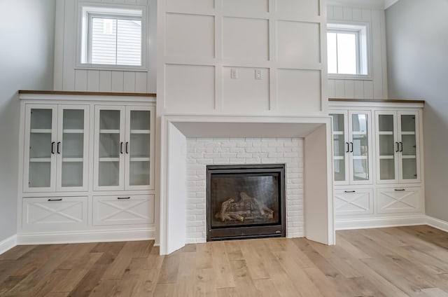 unfurnished living room with a fireplace and wood finished floors