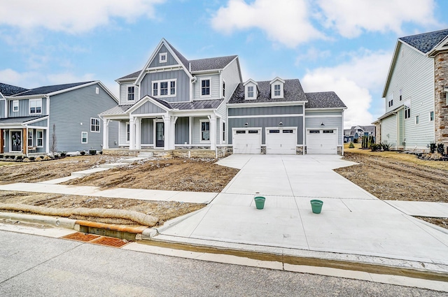 view of front facade featuring concrete driveway, an attached garage, board and batten siding, and a residential view