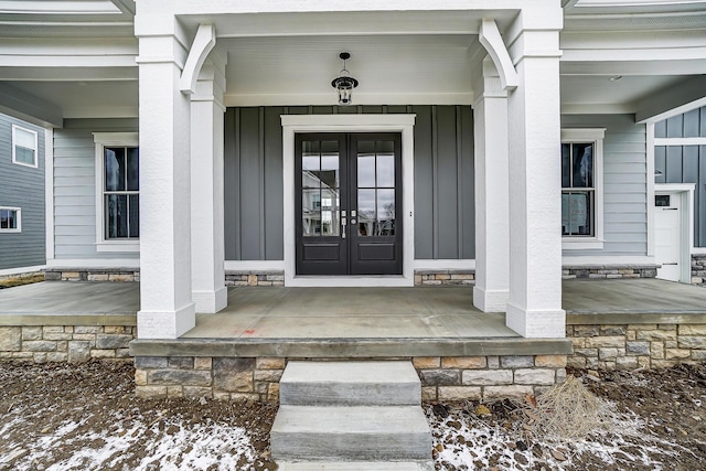 entrance to property with a porch and board and batten siding