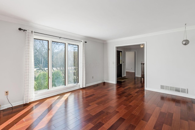 unfurnished room with visible vents, baseboards, dark wood finished floors, and crown molding