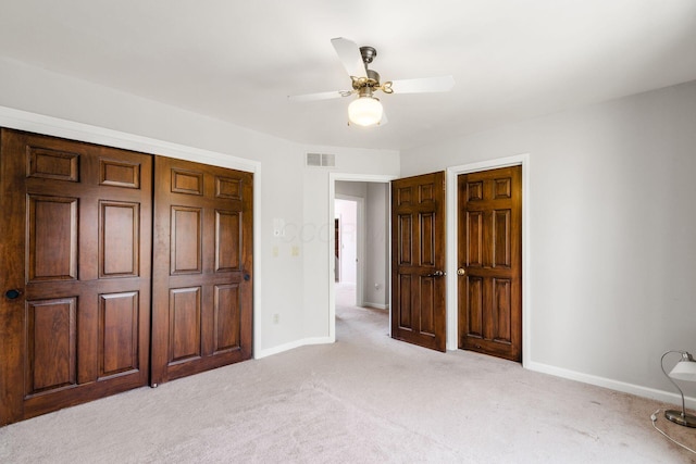 unfurnished bedroom with visible vents, ceiling fan, baseboards, carpet flooring, and a closet