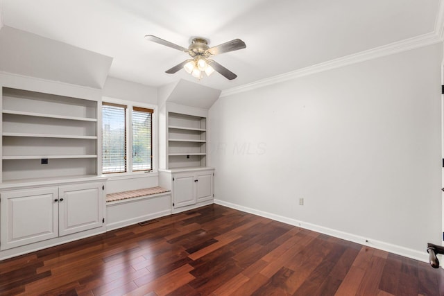 spare room featuring visible vents, dark wood-type flooring, a ceiling fan, crown molding, and baseboards