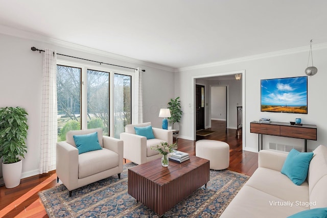 living area with wood finished floors, baseboards, and ornamental molding