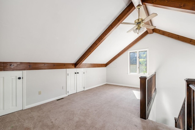 bonus room featuring lofted ceiling with beams, carpet flooring, and visible vents