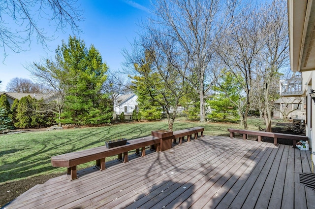 wooden deck featuring a lawn