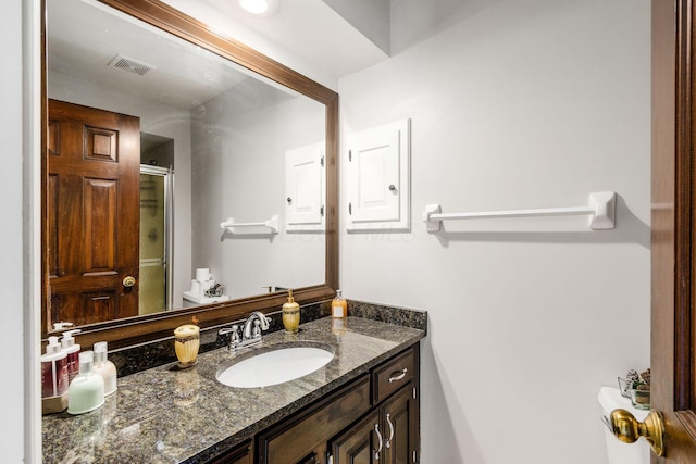 bathroom with visible vents, a stall shower, and vanity