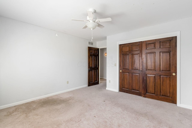 unfurnished bedroom with visible vents, baseboards, carpet, and a ceiling fan