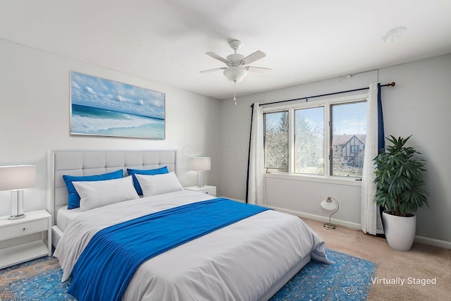 carpeted bedroom with baseboards and a ceiling fan